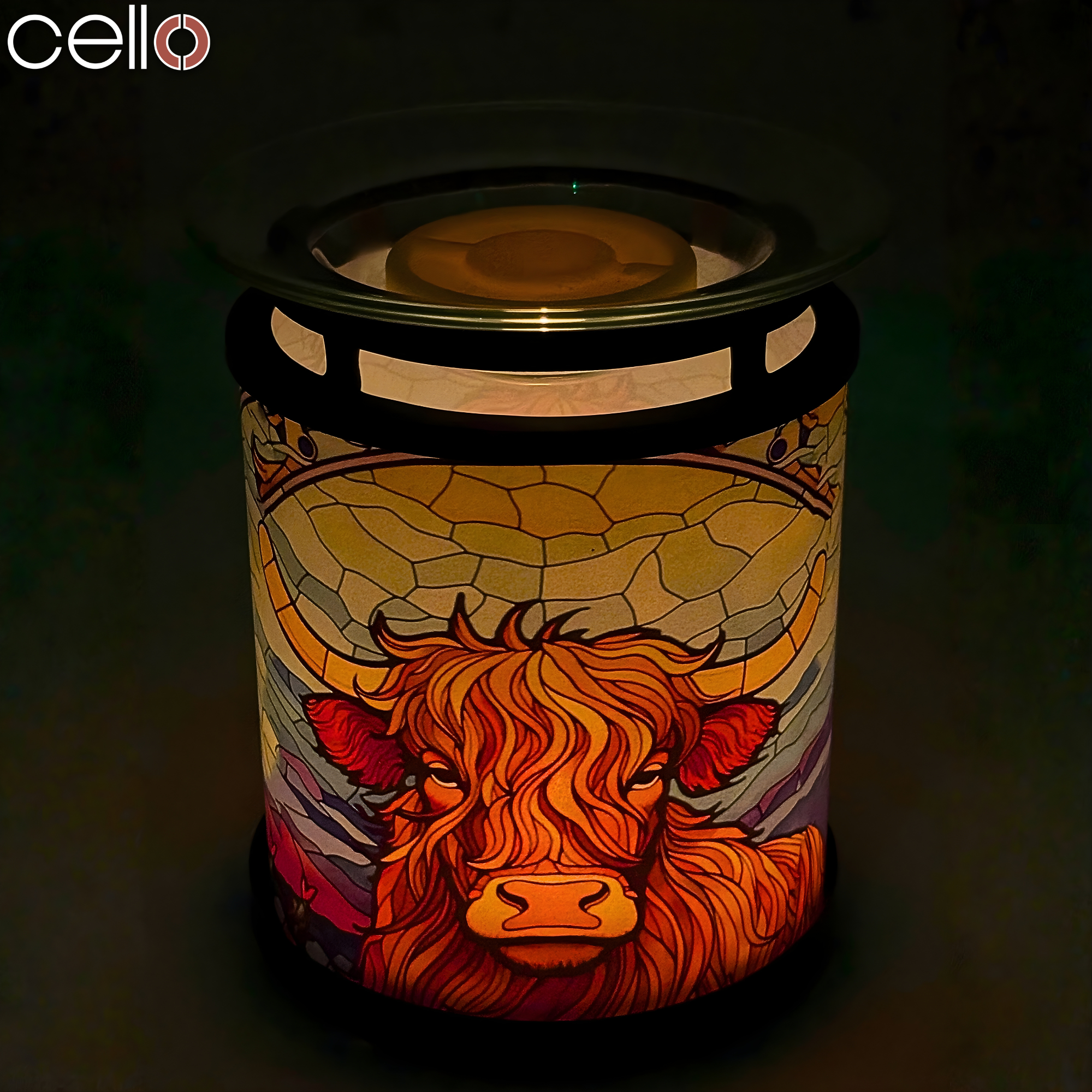 Cello Highland Cow Tealight Wax Warmer illuminated at night, showing stained-glass Highland cattle design – stylish Highland cow lamp or light-up gift.