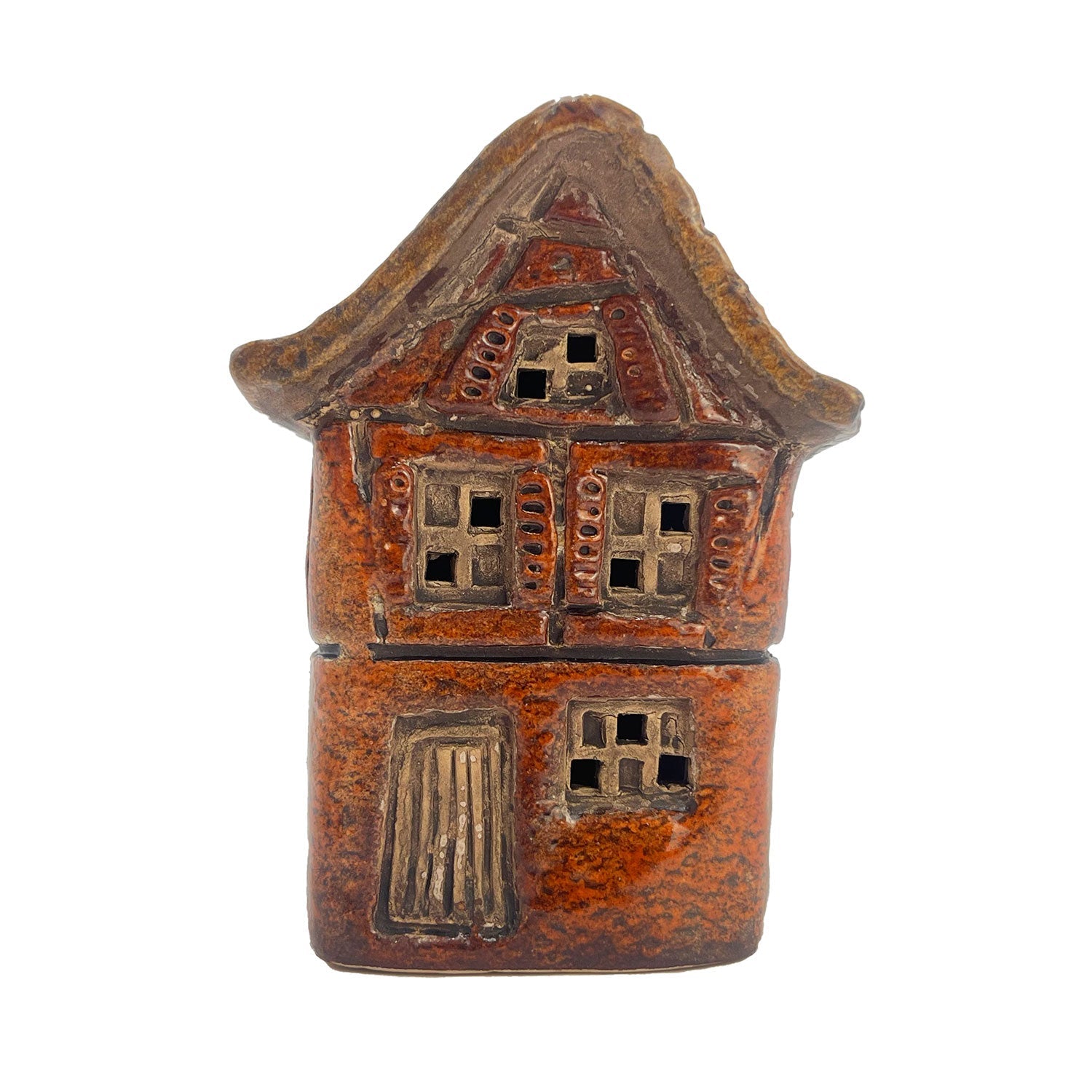 Front angle view of the Cello Silk Weaver’s Cottage in warm orange tones with glowing LED light illuminating window details.