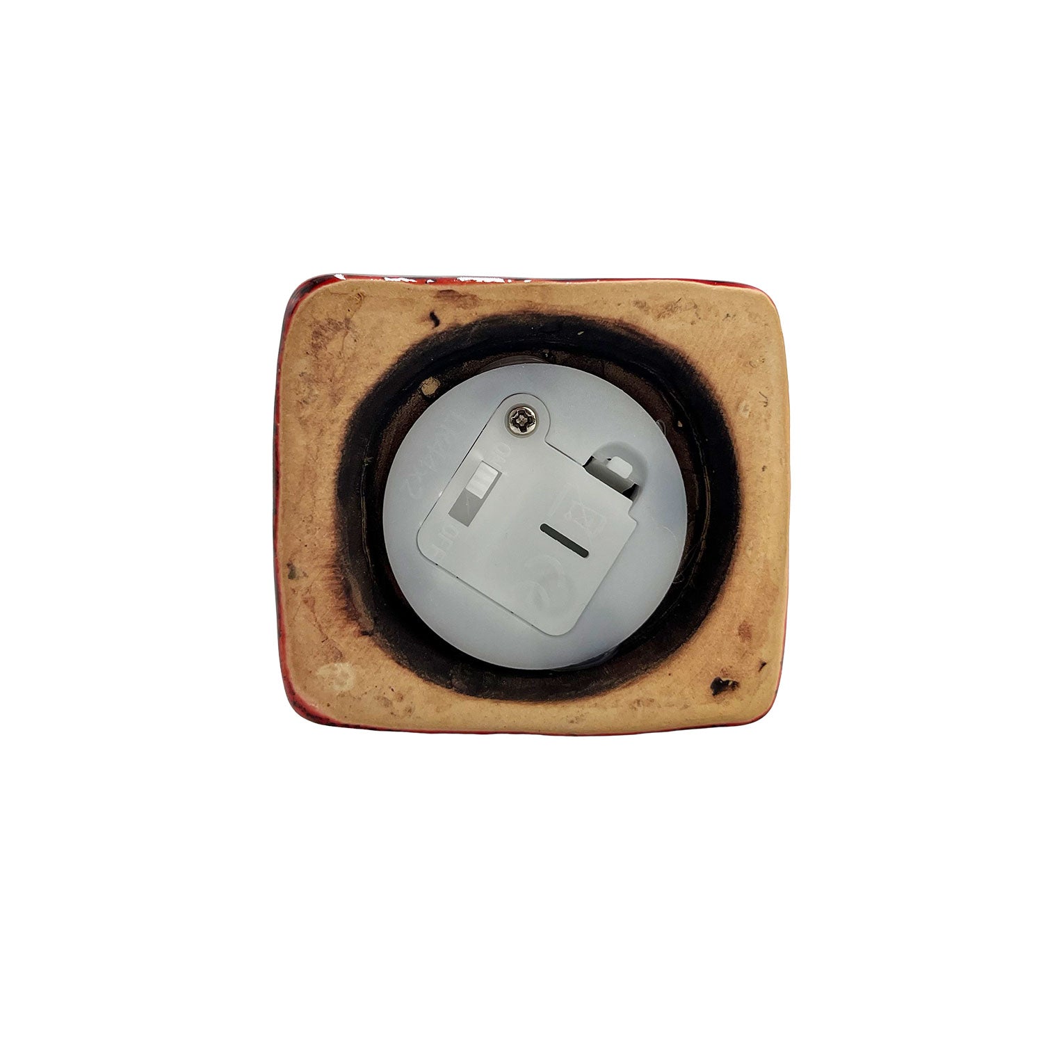 Underside of the Scribe’s Retreat LED pottery house showing battery compartment and switch for easy operation.