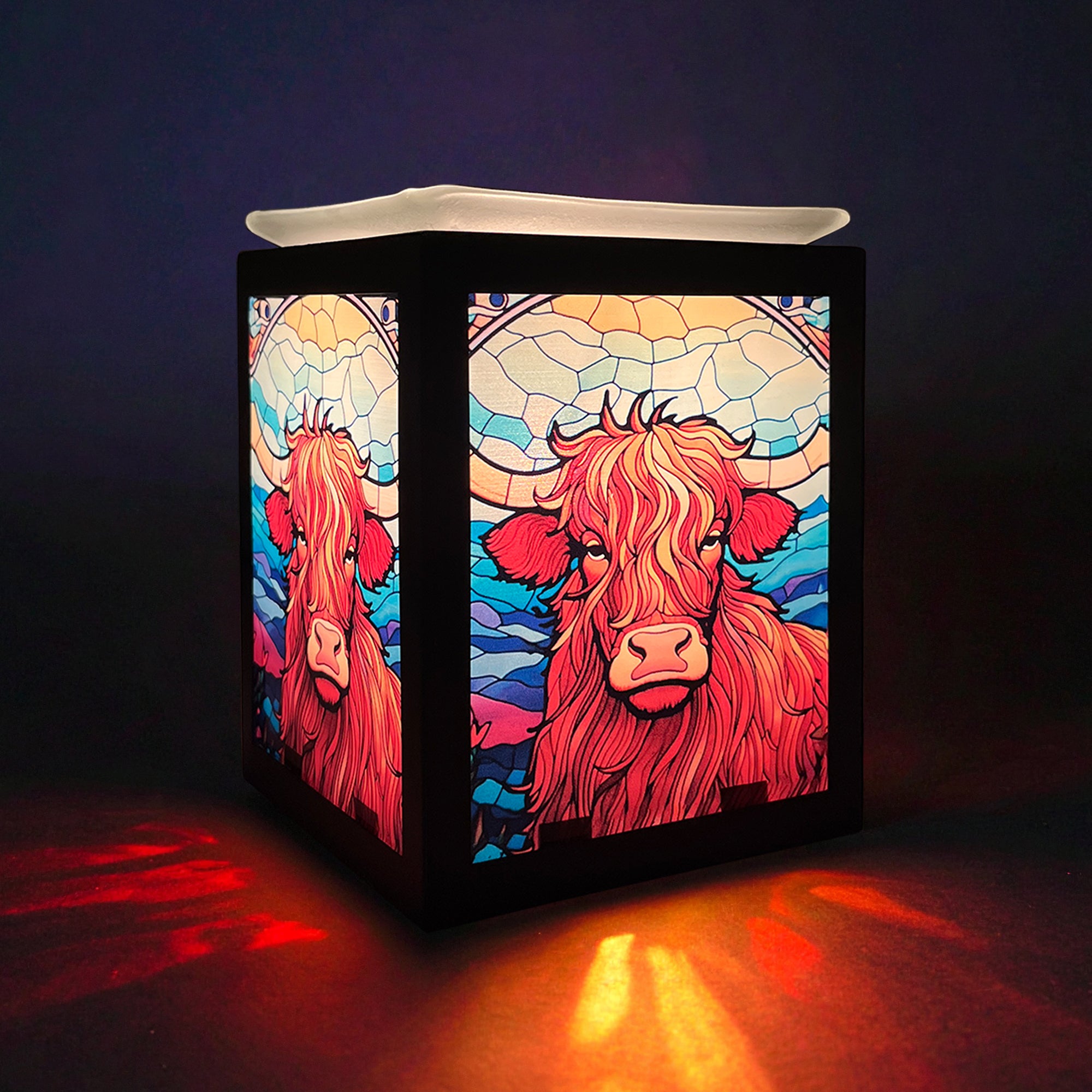 Highland Cow Electric Wax Melt Burner glowing in a cosy home setting, adding warmth and countryside charm to modern décor.