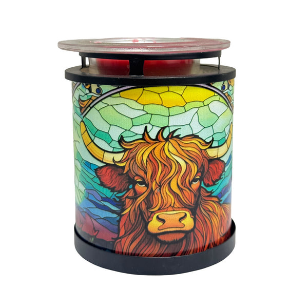 Cello Highland Cow Wax Warmer illuminated, showcasing stained-glass-style light and rustic cow design for cosy home fragrance.