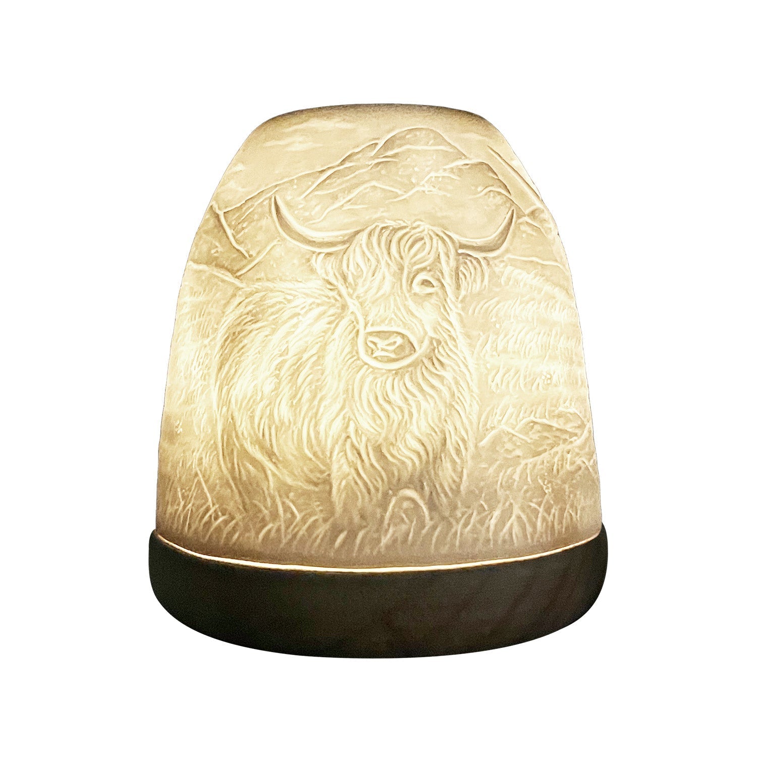 Close-up side view of glowing Highland Cow lithophane tealight candle dome